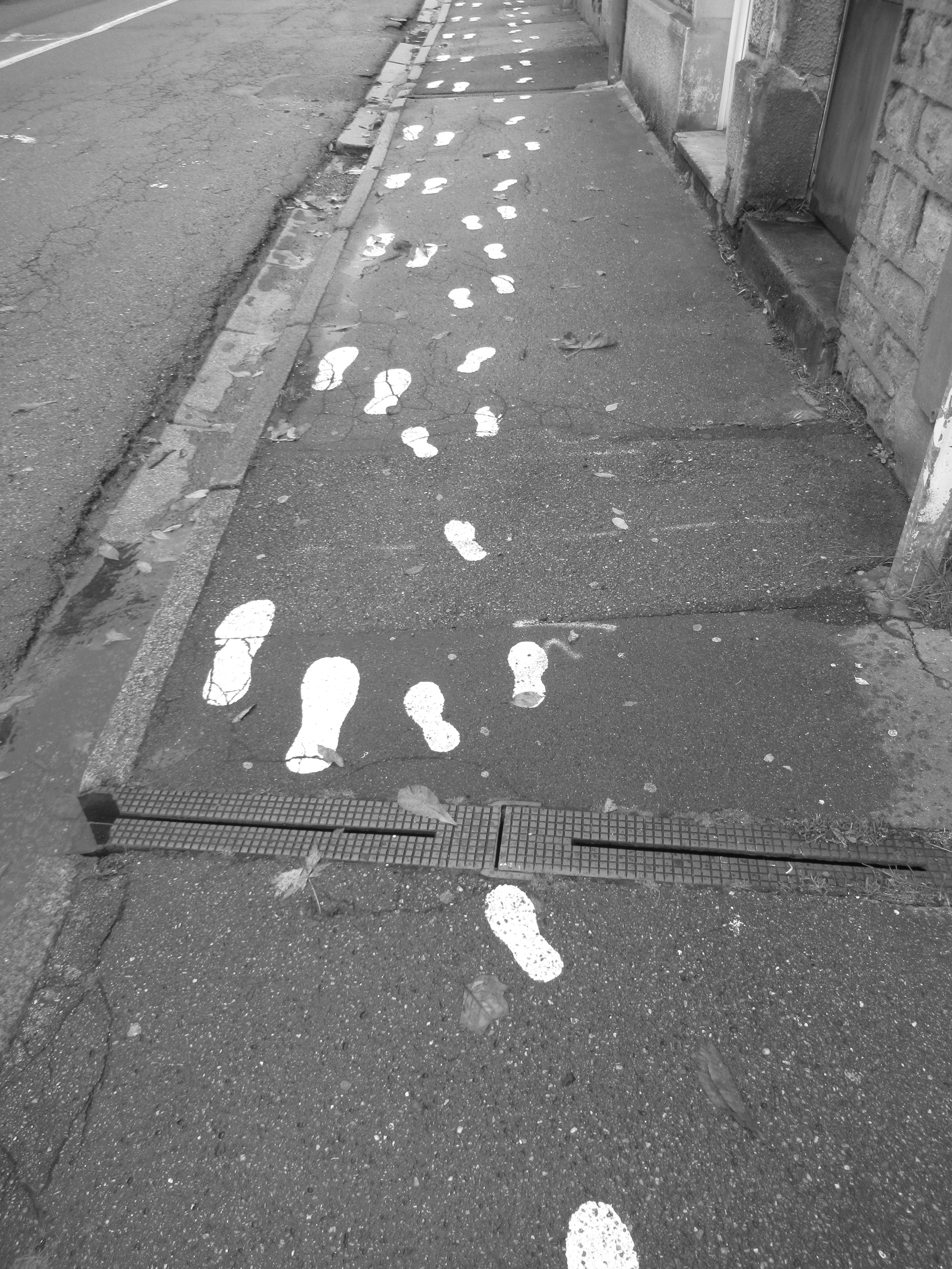 Painting of footprints on a roadway