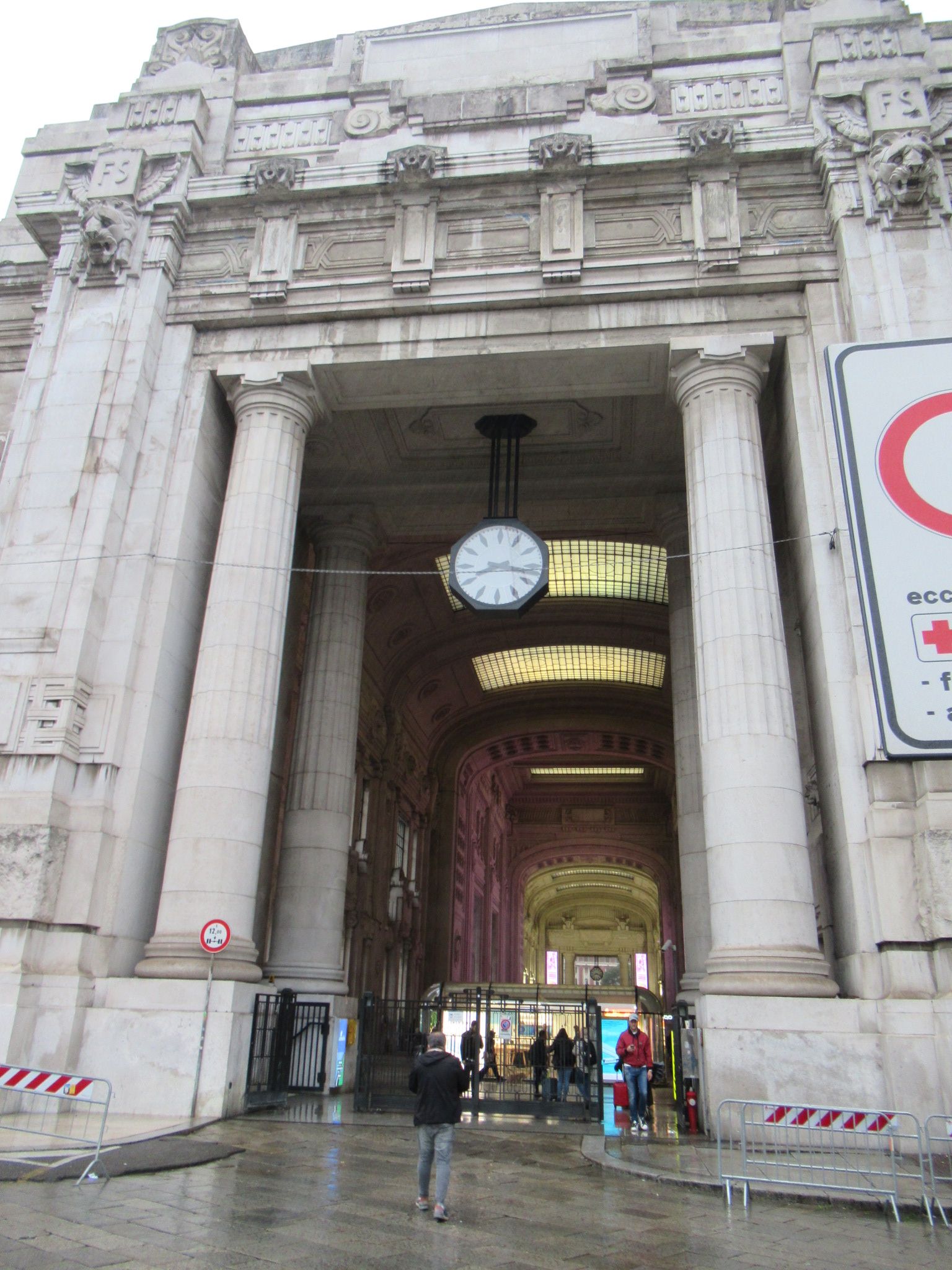 L'entrée de la gare centrale, avec horloge suspendu au plafond dans la ville de Milan Lombardie en Italie photo gratuite
