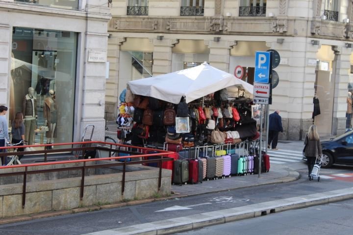 A market stall selling travel and leather goods on an alley corner, mainly suitcases and bags, free photo