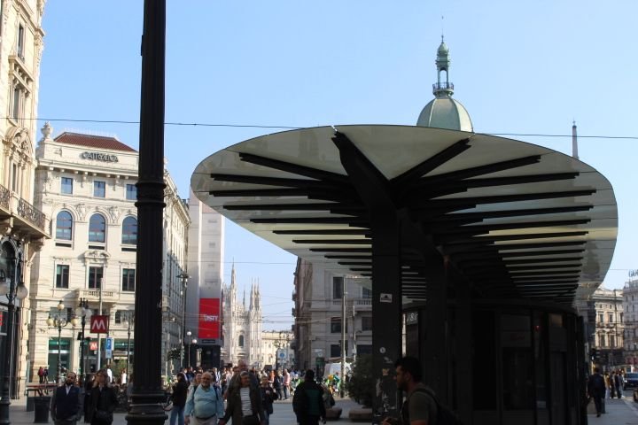 An ATM in Milan, a shelter-like structure located in a public square, probably near a public transport station, free photo