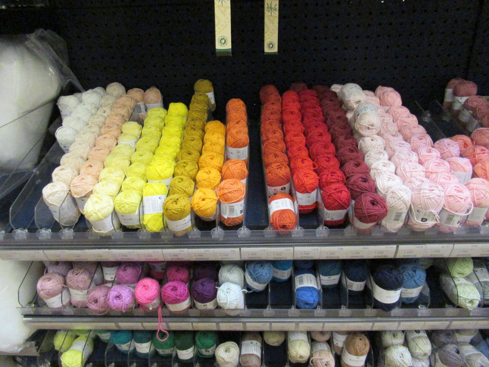 Woolen threads arranged by color in a store