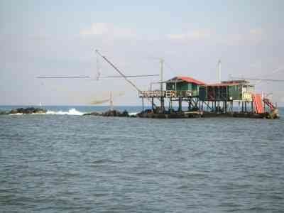 Une cabane de pêche traditionnelle en bois construite sur des pilotis, typique de la Bocca d'Arno à Marina di Pisa, en Italie, photo gratuite