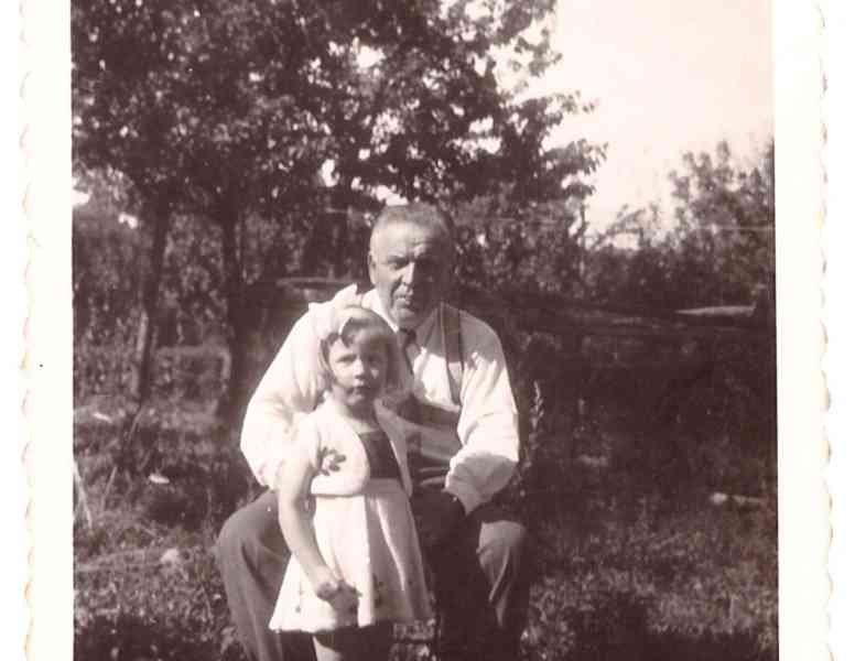 Vintage black and white photograph of an elderly man holding a little girl (free image)
