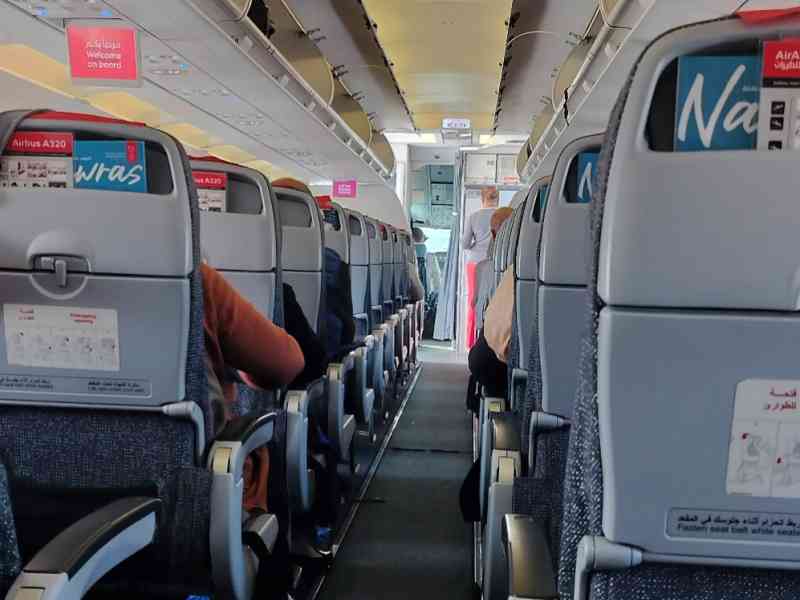 The narrow aisle inside an airplane free photo