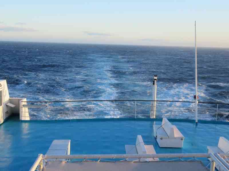 Le pont arrière d'un bateau de croisière, avec le sillage dans l'océan, photo gratuite