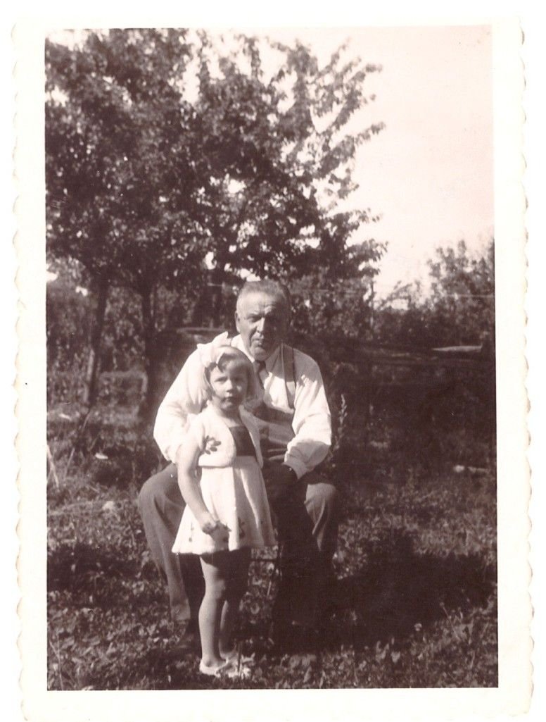 Vintage black and white photograph of an elderly man holding a little girl (free image)